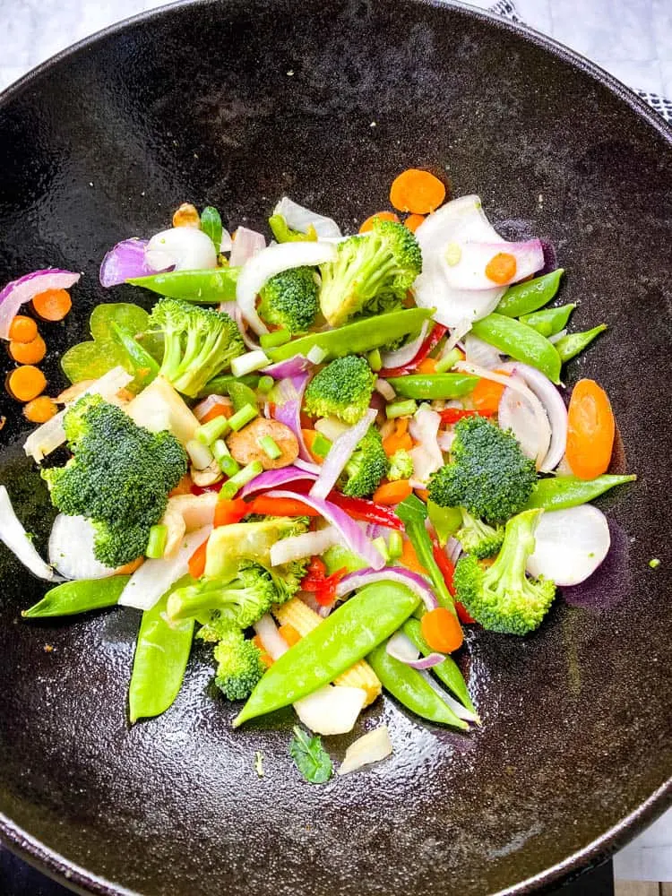 raw vegetables in a cast iron wok