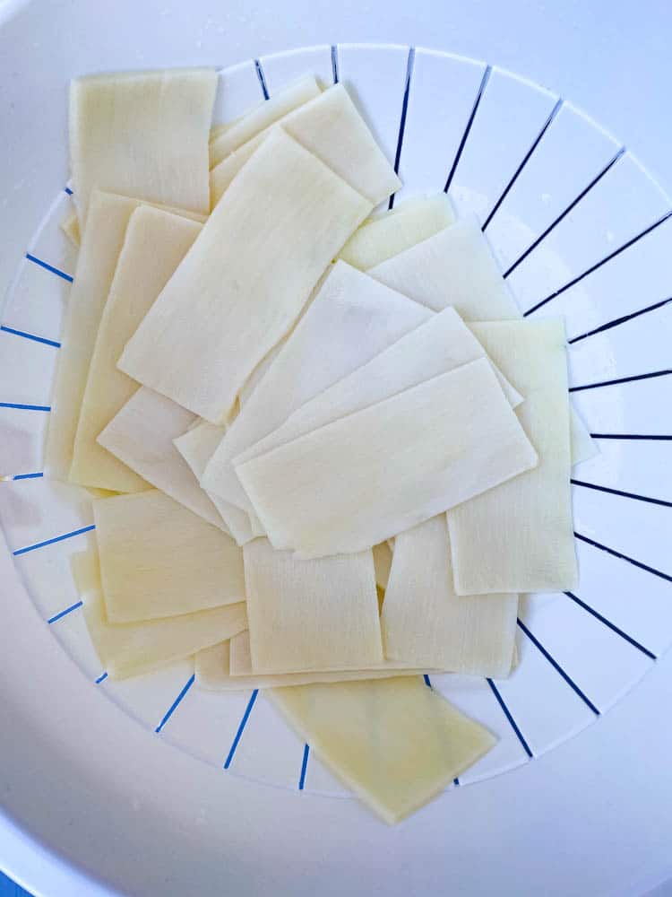 rinsed Palmini lasagna sheets in a white bowl