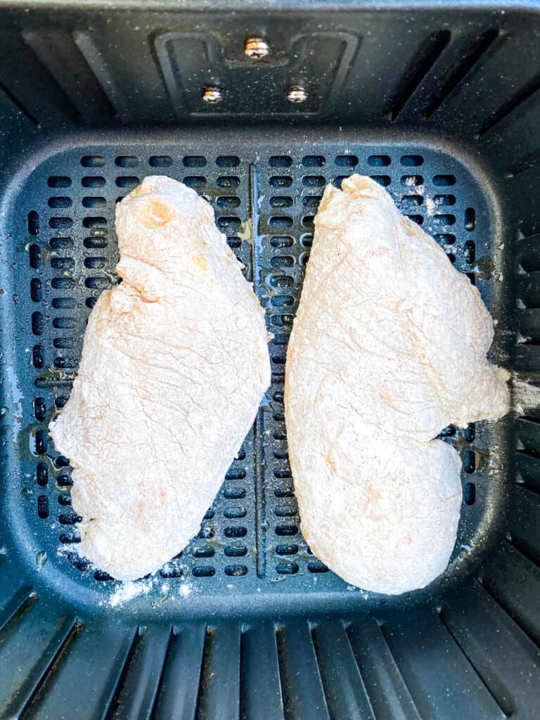 raw breaded chicken breasts in an air fryer