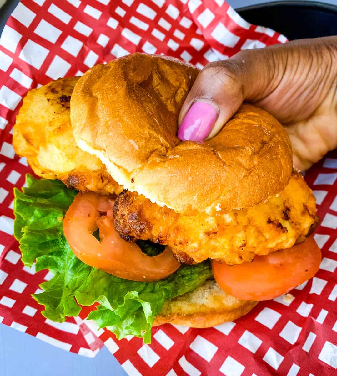 person holding chick-fil-a chicken sandwich