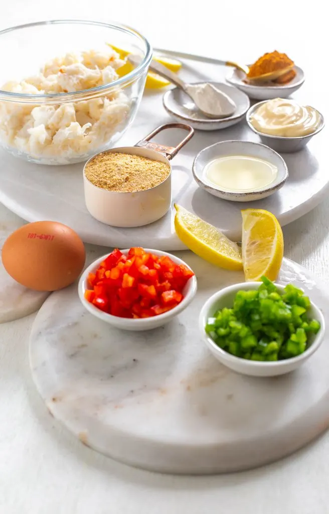 red peppers, green peppers, lemon, lump crab, mayo, and garlic in separate bowls