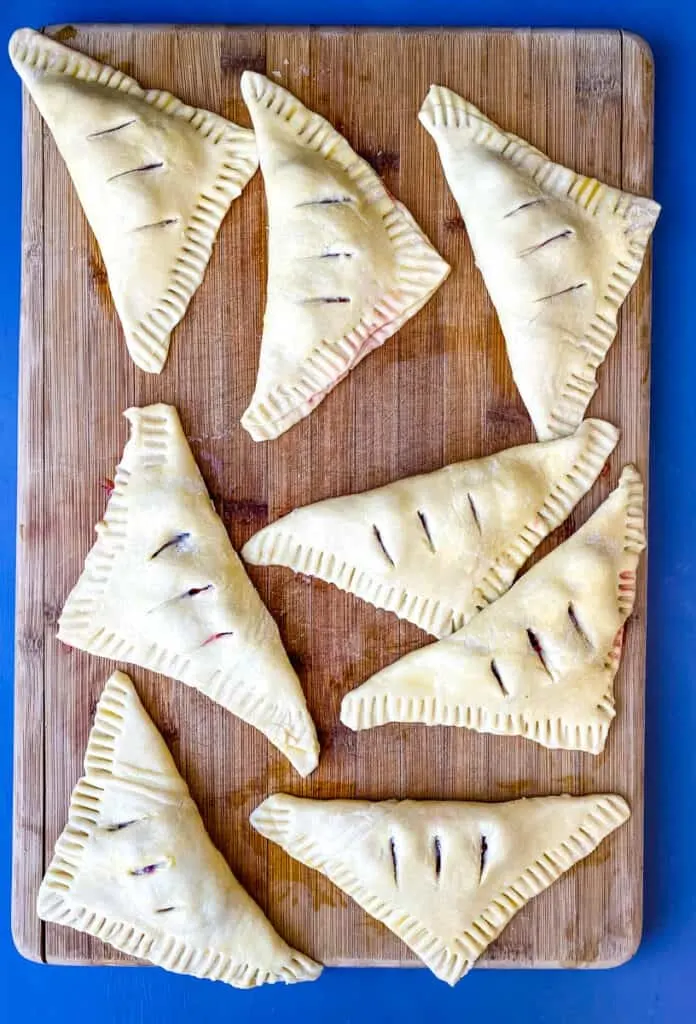 unbaked puff pastry on a bamboo cutting board