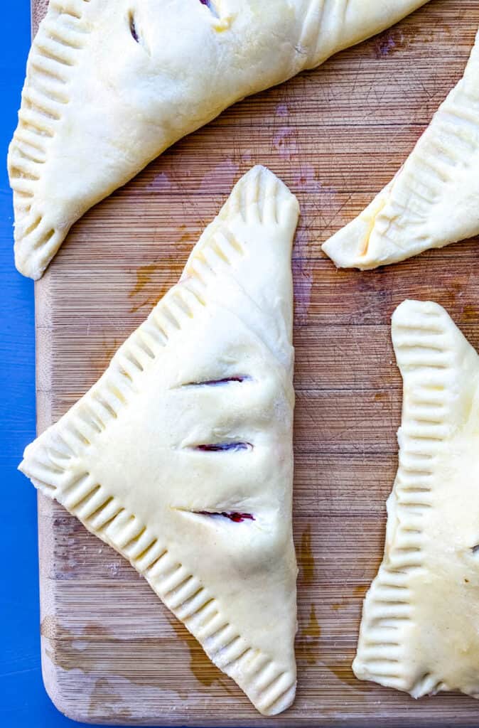 unbaked puff pastry on a bamboo cutting board