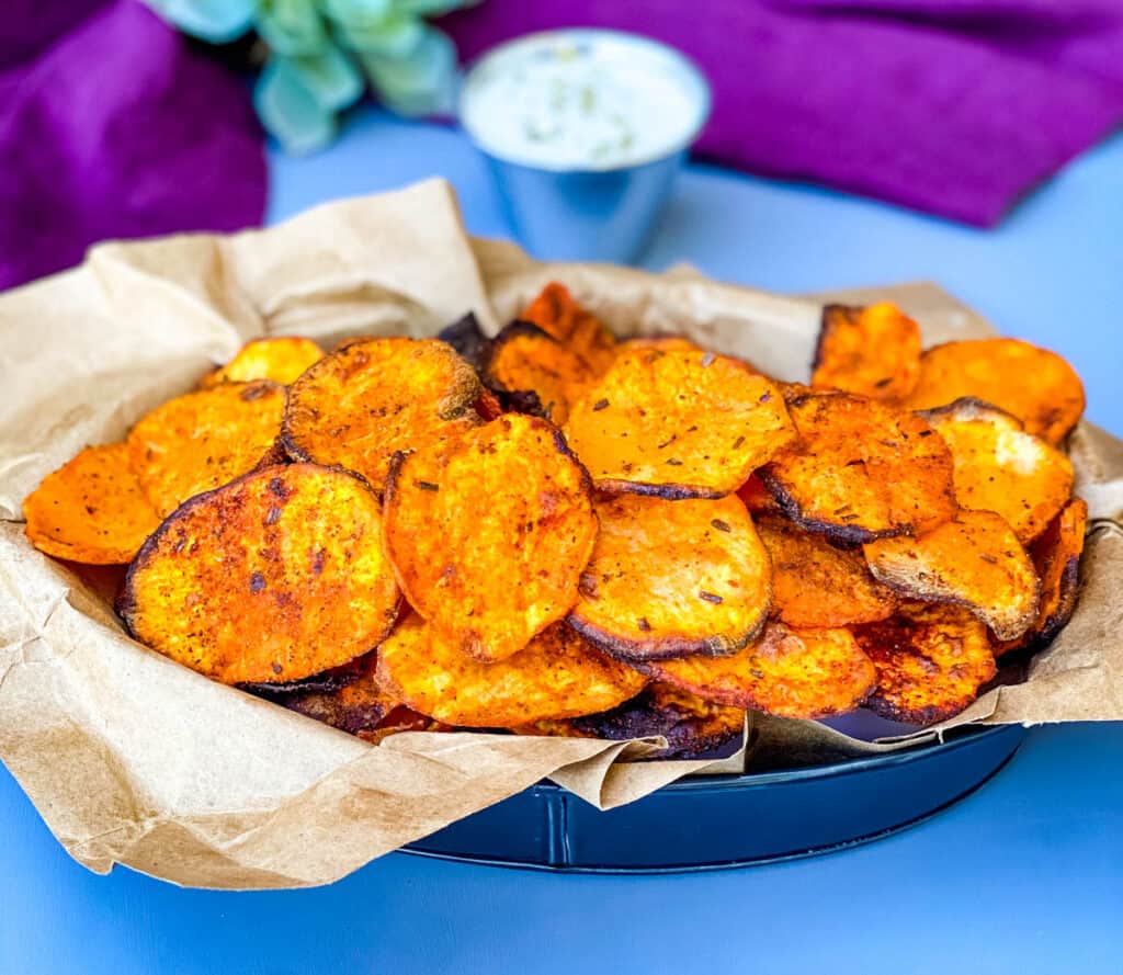 air fryer sweet potato chips in a black bowl with dipping sauce