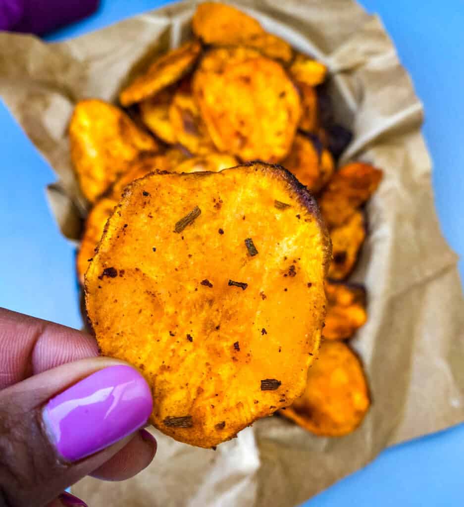 person holding air fryer sweet potato chip