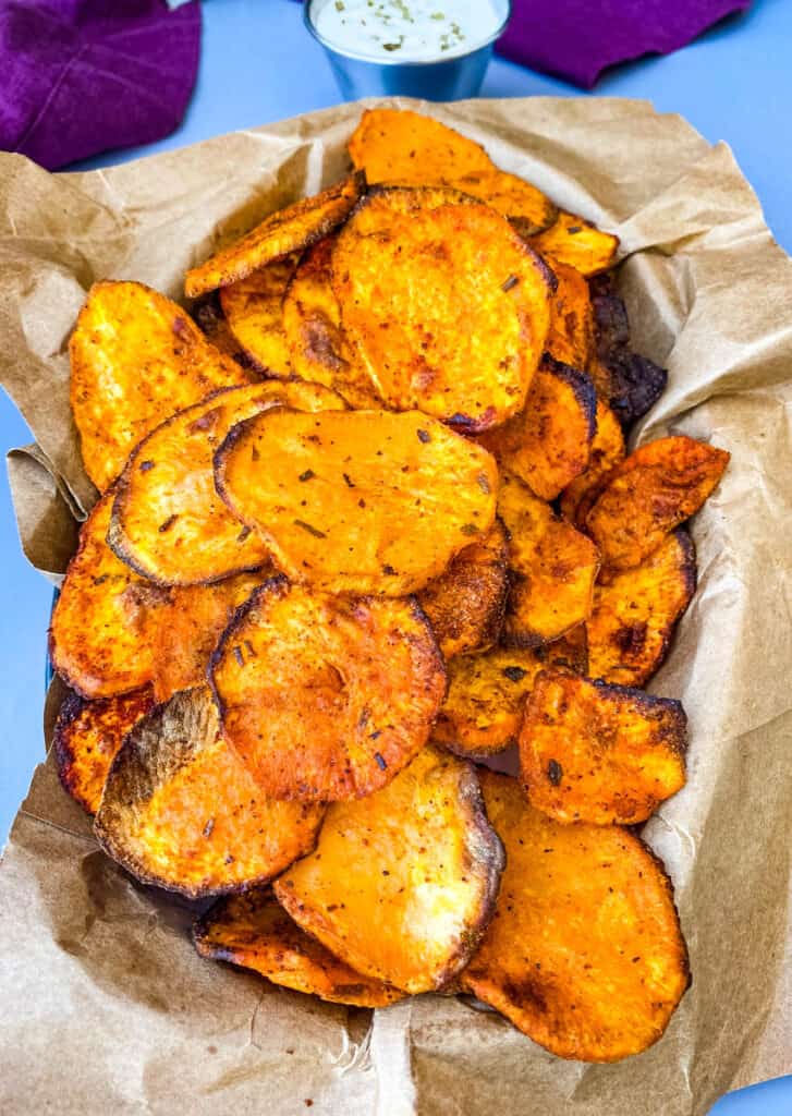 air fryer sweet potato chips in a black bowl with dipping sauce