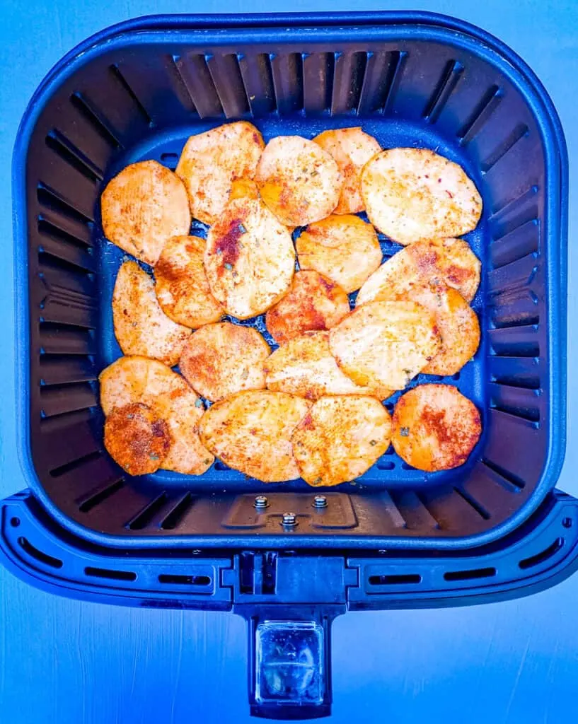 raw sliced sweet potato chips in an air fryer