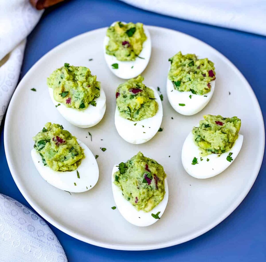 avocado deviled eggs on a white plate