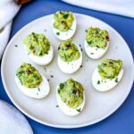 avocado deviled eggs on a white plate