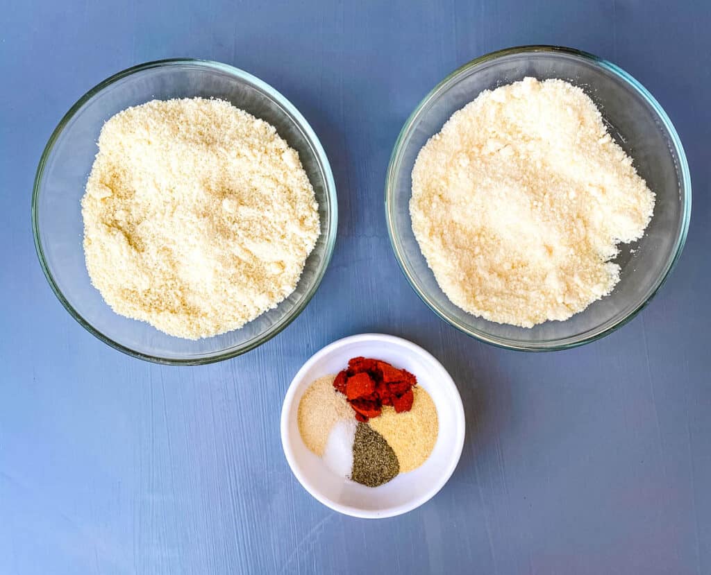 grated parmesan, almond flour, and seasonings in separate bowls