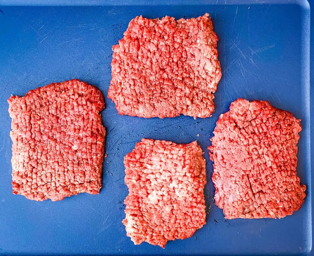 raw cube steak on a cutting board