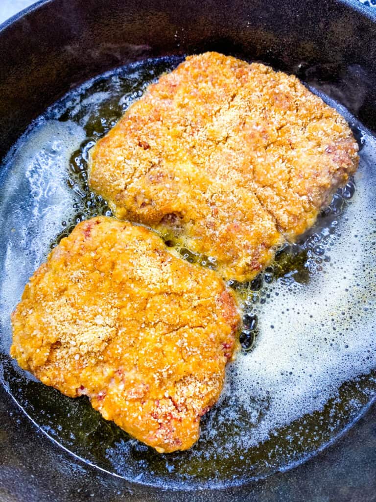 keto chicken fried steak fried in a cast iron skillet