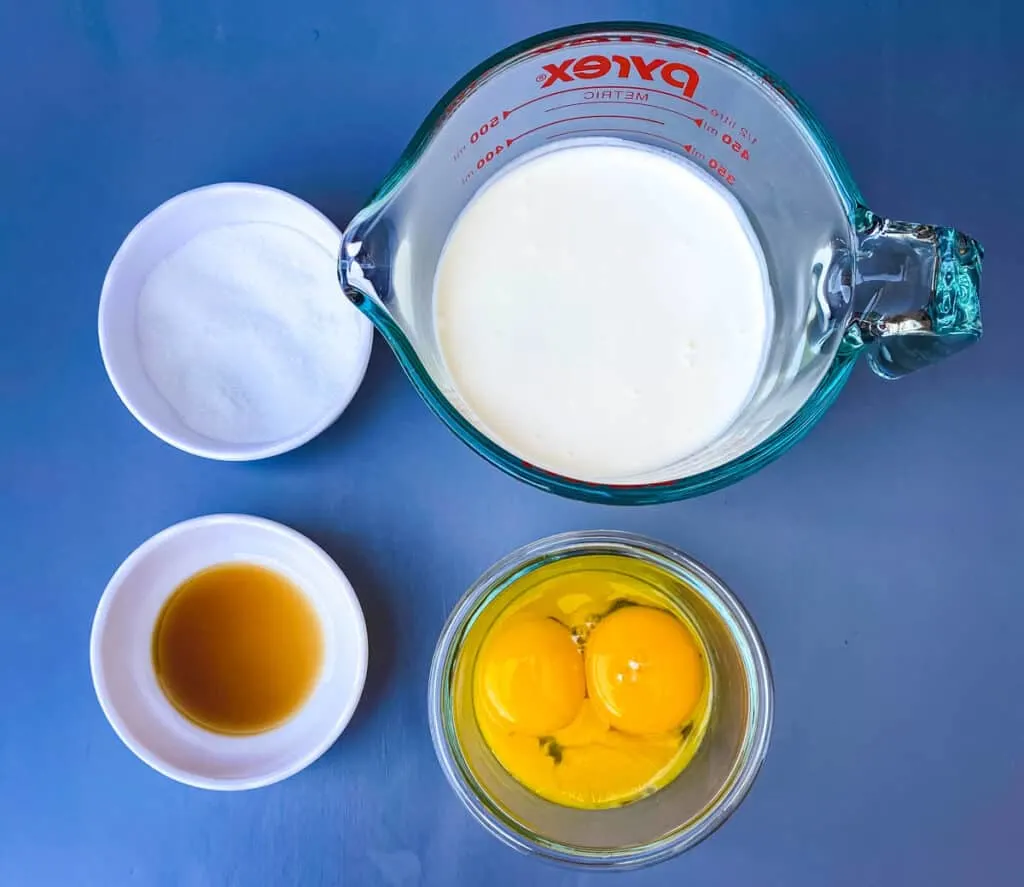 sweetener, vanilla extract, heavy whipping cream, and egg yolks in separate bowls