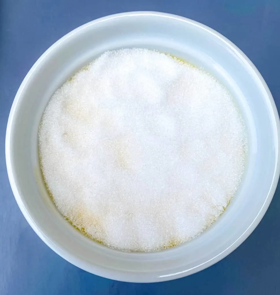 keto low carb Crème brûlée custard mixture in a white ramekin with sweetener sprinkled on top