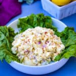 keto low carb egg salad on a bed of lettuce in a white bowl
