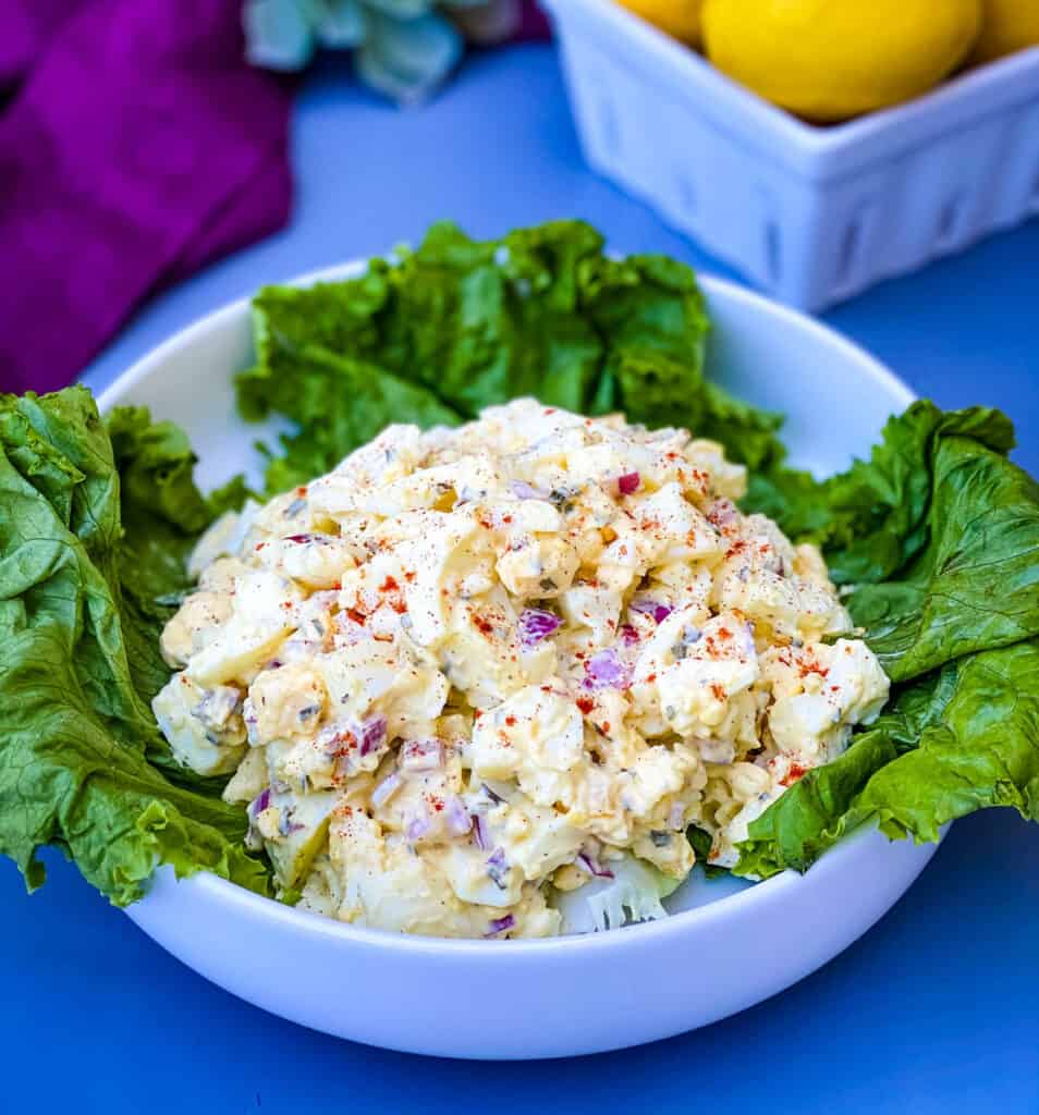 keto low carb egg salad on a bed of lettuce in a white bowl