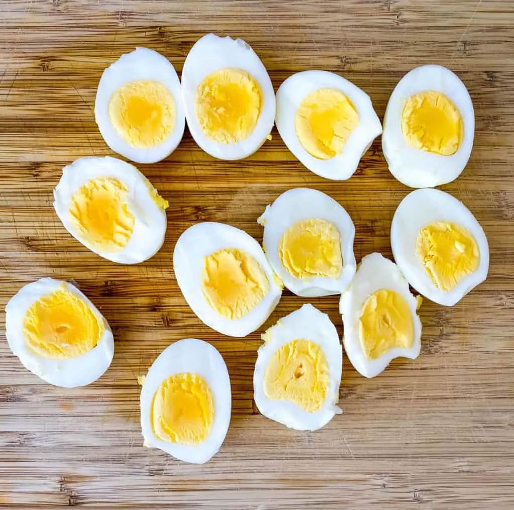 hard boiled eggs sliced in half on a cutting board