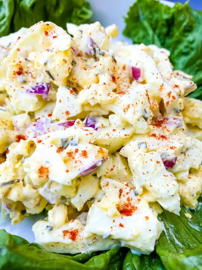 keto low carb egg salad on a bed of lettuce in a white bowl