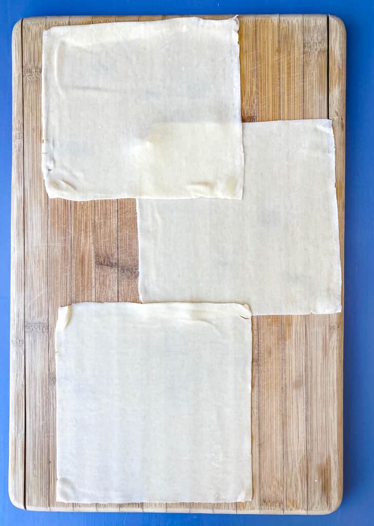 egg roll wrappers on a cutting board