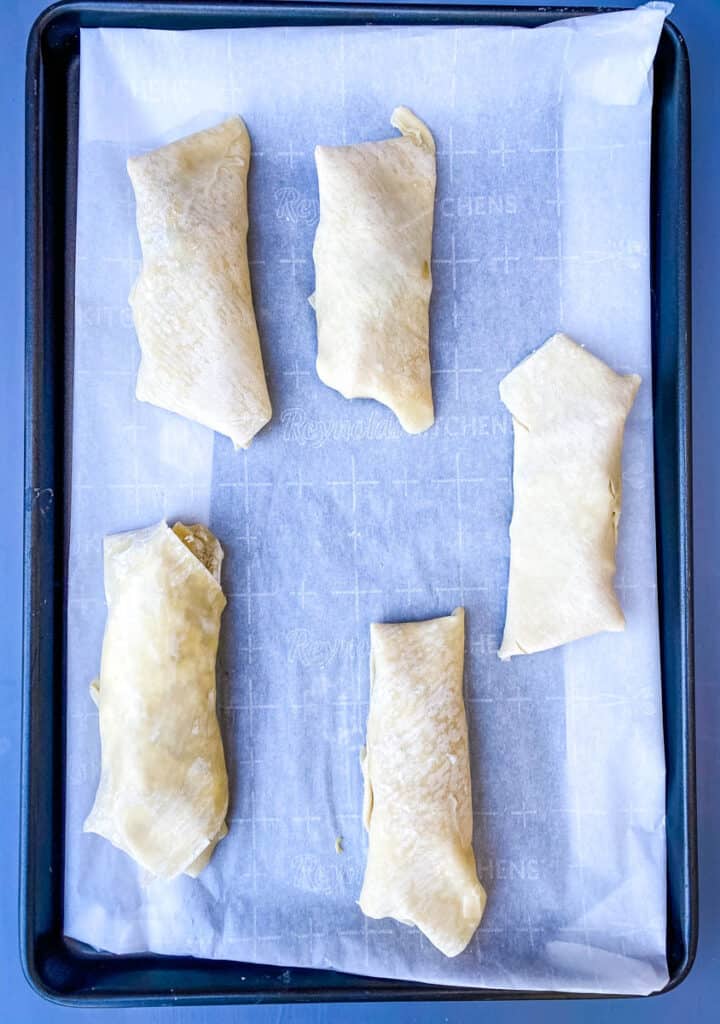 shrimp egg rolls on a sheet pan lined with parchment paper