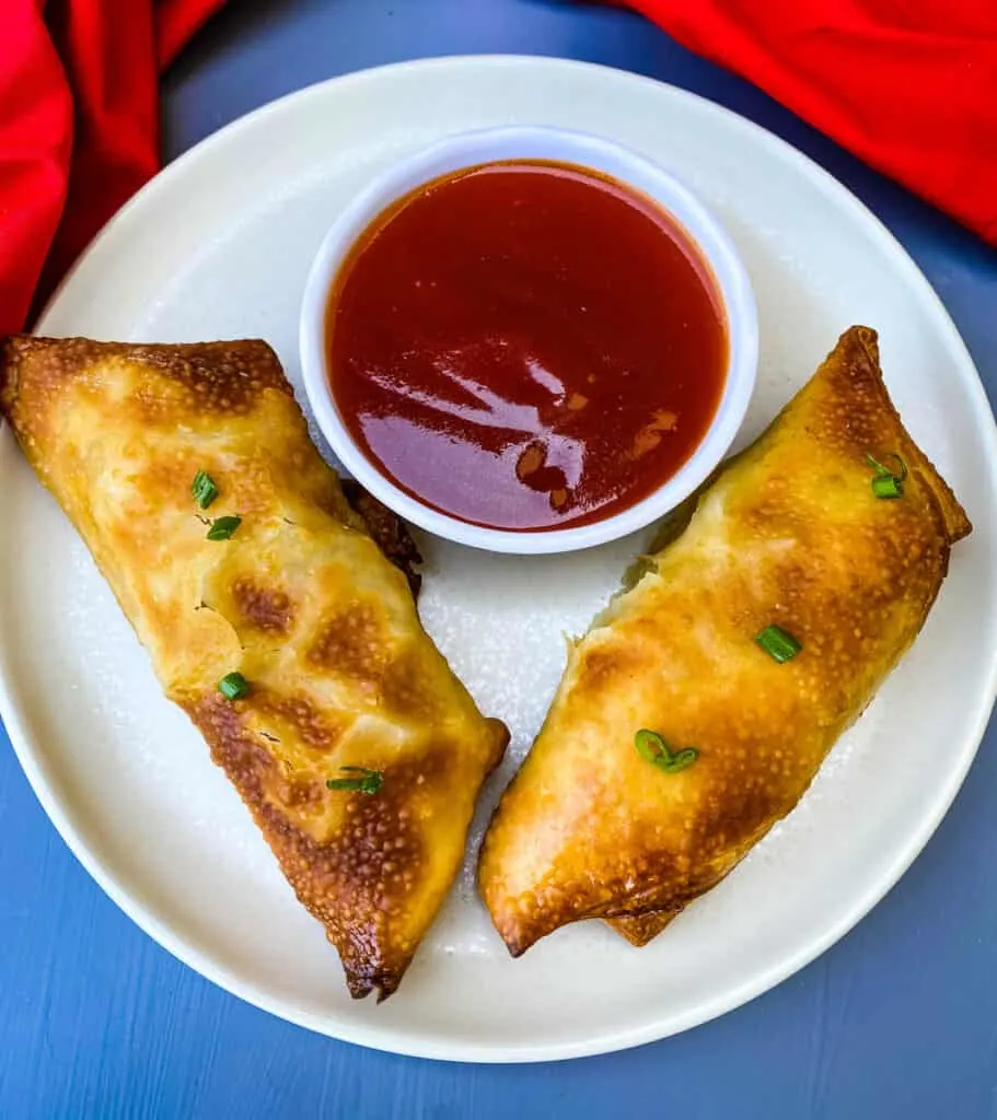 shrimp egg rolls with sweet and sour sauce on a plate