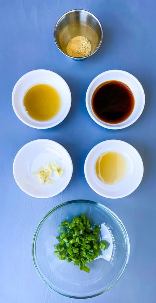 sesame oil, fish sauce, garlic, green onions, soy sauce, and ginger in separate bowls
