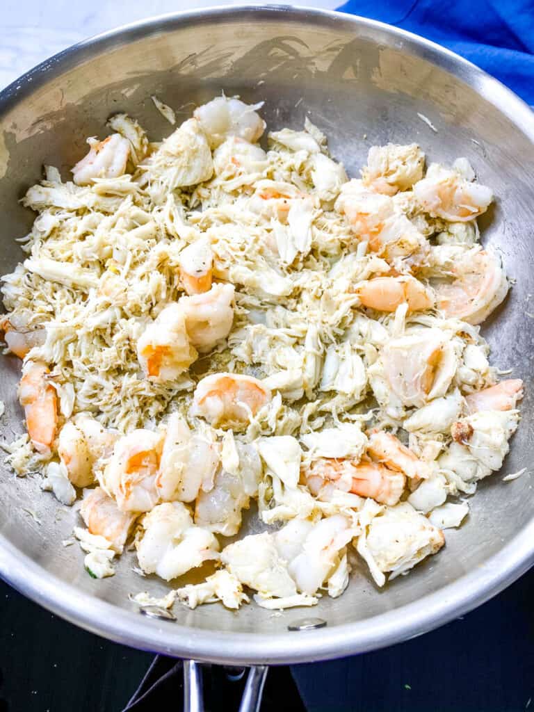 shrimp and crab in a frying pan