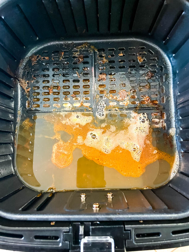 air fryer basket with water and dish liquid