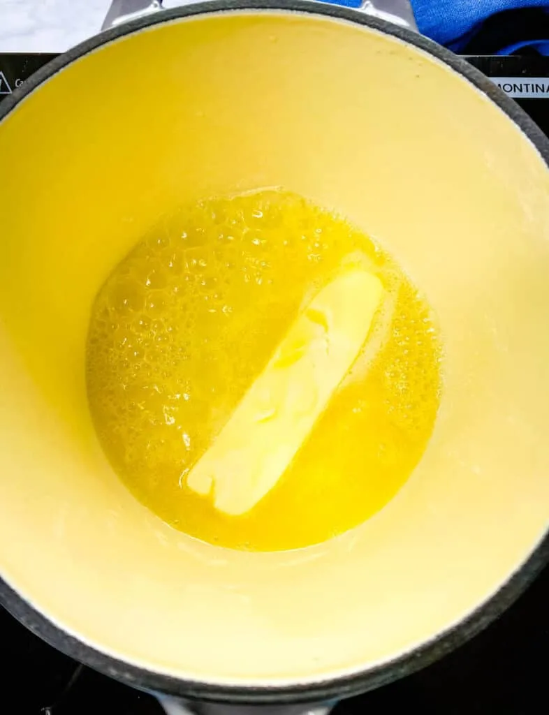 a stick of butter melting in a saucepan