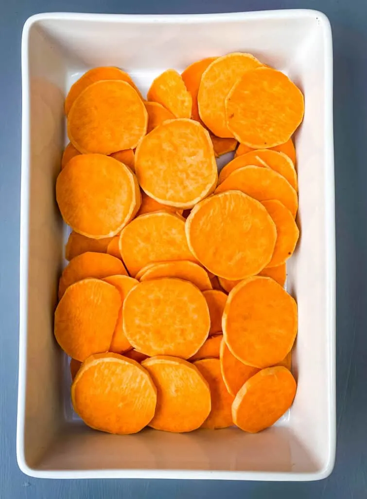 sliced sweet potatoes in a baking dish