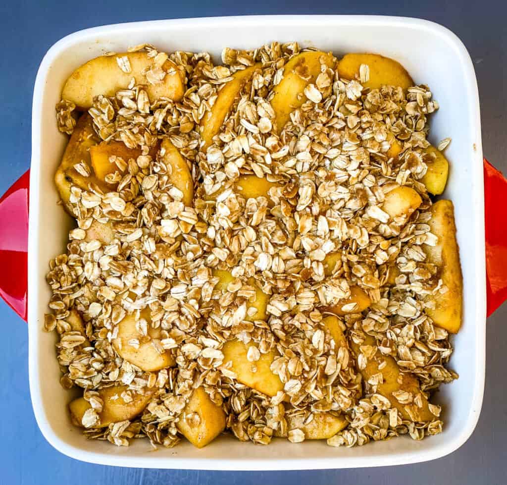 healthy apple crisp in a red baking dish