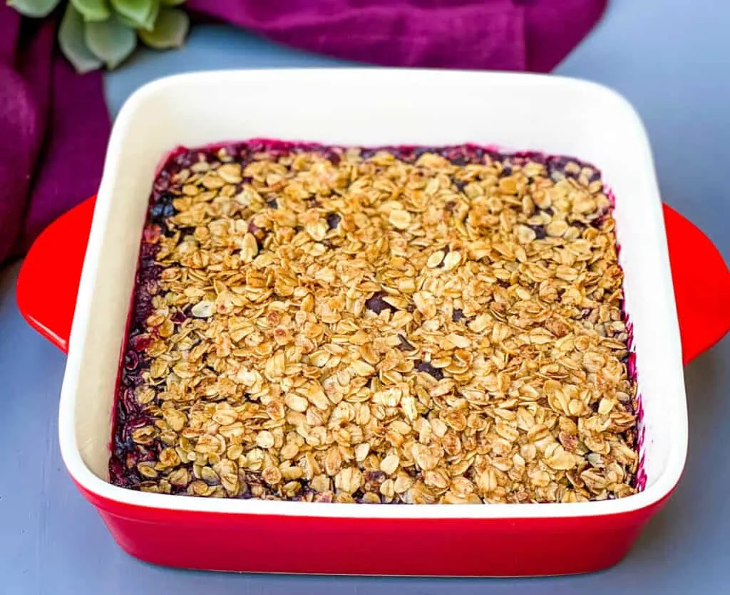 healthy blueberry crisp in a red baking dish
