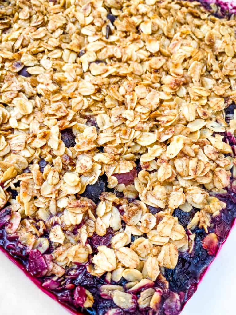 healthy blueberry crisp in a red baking dish