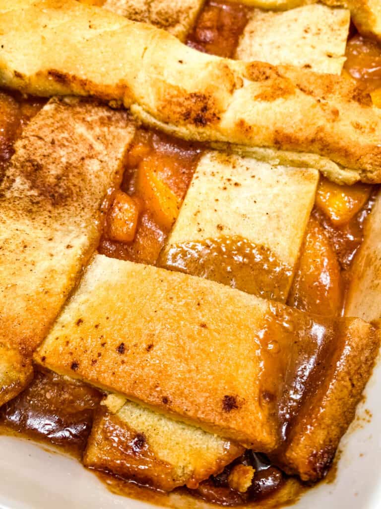 baked healthy Southern peach cobbler in a red baking dish