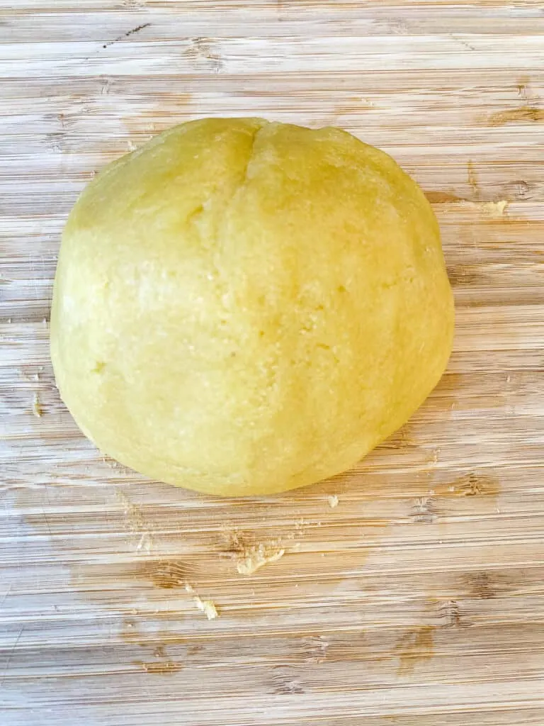 almond flour crust and dough rolled into a ball on a flat surface