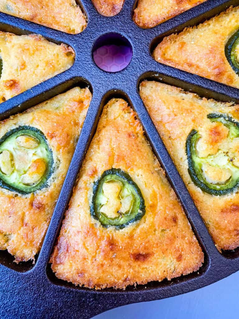 jalapeno cheddar cornbread in a cast iron wedge pan