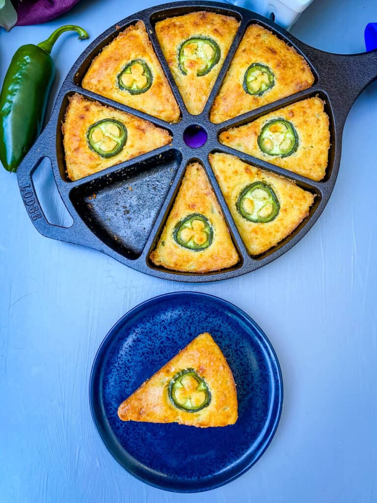 a plate of jalapeno cheddar cornbread along with jalapeno cheddar cornbread in a cast iron wedge pan