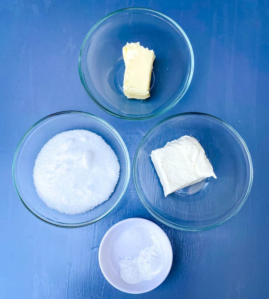 butter, cream cheese, sweetener, baking powder, and salt in separate bowls on a flat surface