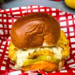 air fryer fish sandwich on a bun with melted cheese and tartar sauce