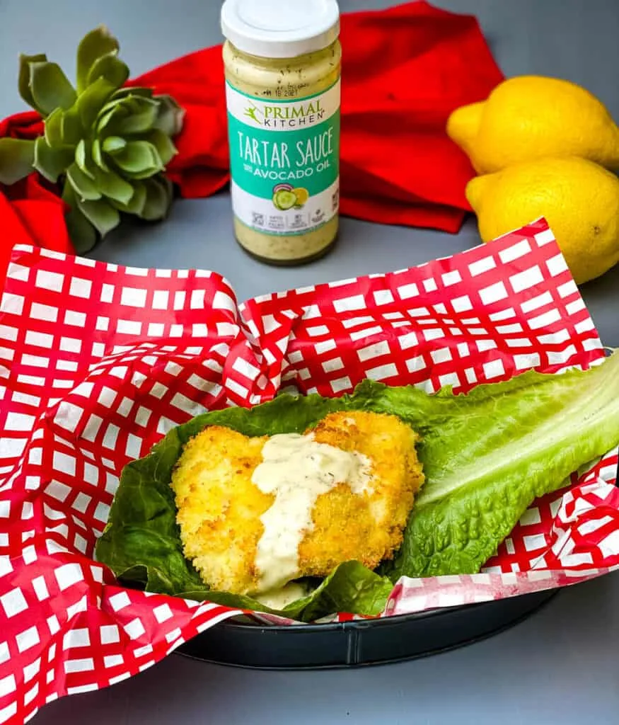 air fryer fish sandwich on a lettuce wrap with melted cheese and tartar sauce