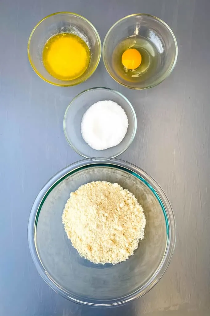 melted butter, raw egg, sweetener, and almond flour in separate glass bowls