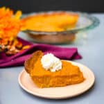 healthy sweet potato pie on a pie plate with whipped cream