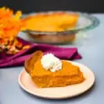 healthy sweet potato pie on a pie plate with whipped cream