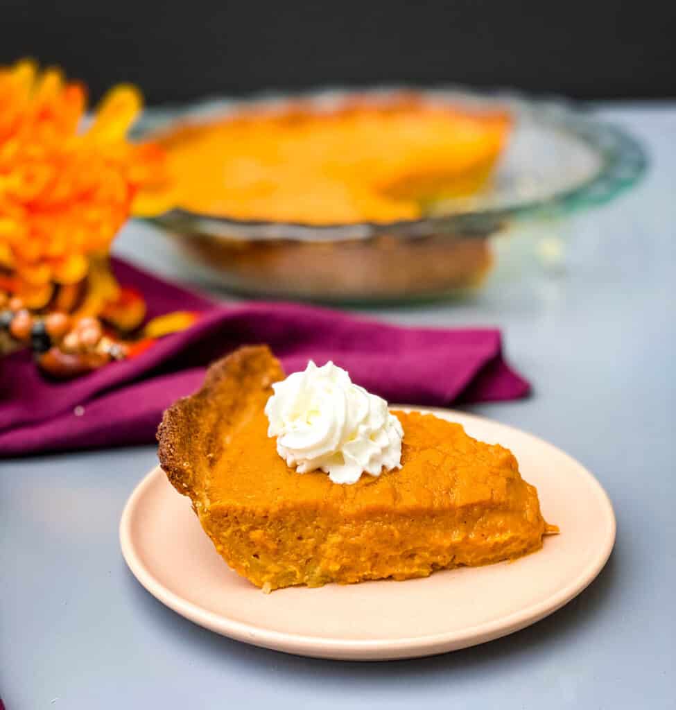 healthy sweet potato pie on a pie plate with whipped cream