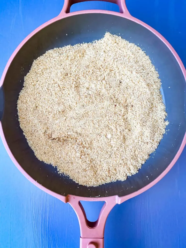 toasted almond flour in a pink pan