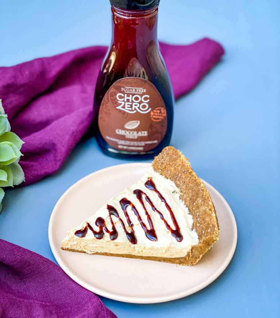 low carb healthy peanut butter pie on a plate with chocolate syrup