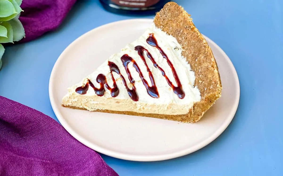 low carb healthy peanut butter pie on a plate with chocolate syrup