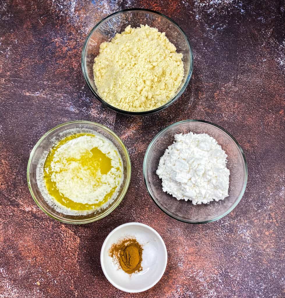 almond flour, melted butter, powdered sweetener, and cinnamon in glass bowls