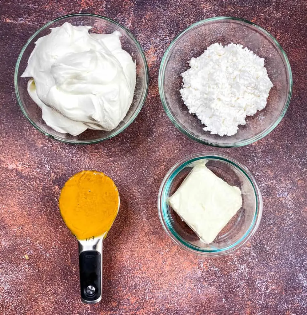 cool whip, powdered sweetener, natural peanut butter, and cream cheese in separate glass bowls