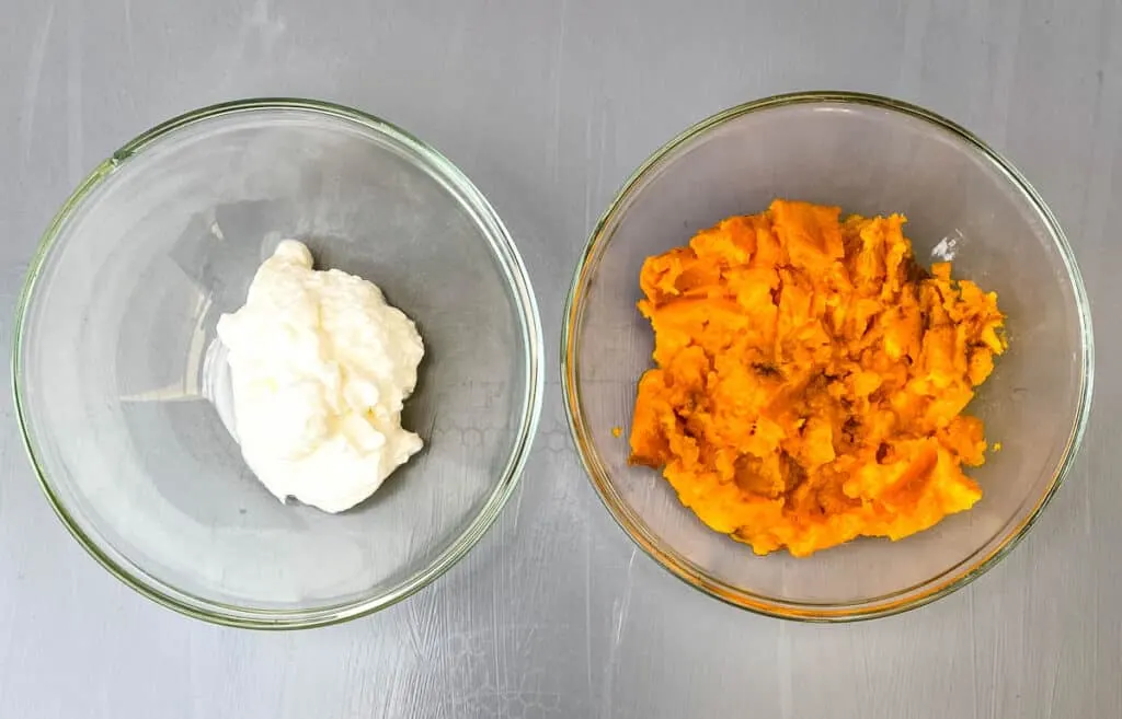Greek yogurt and mashed sweet potatoes in separate glass bowls